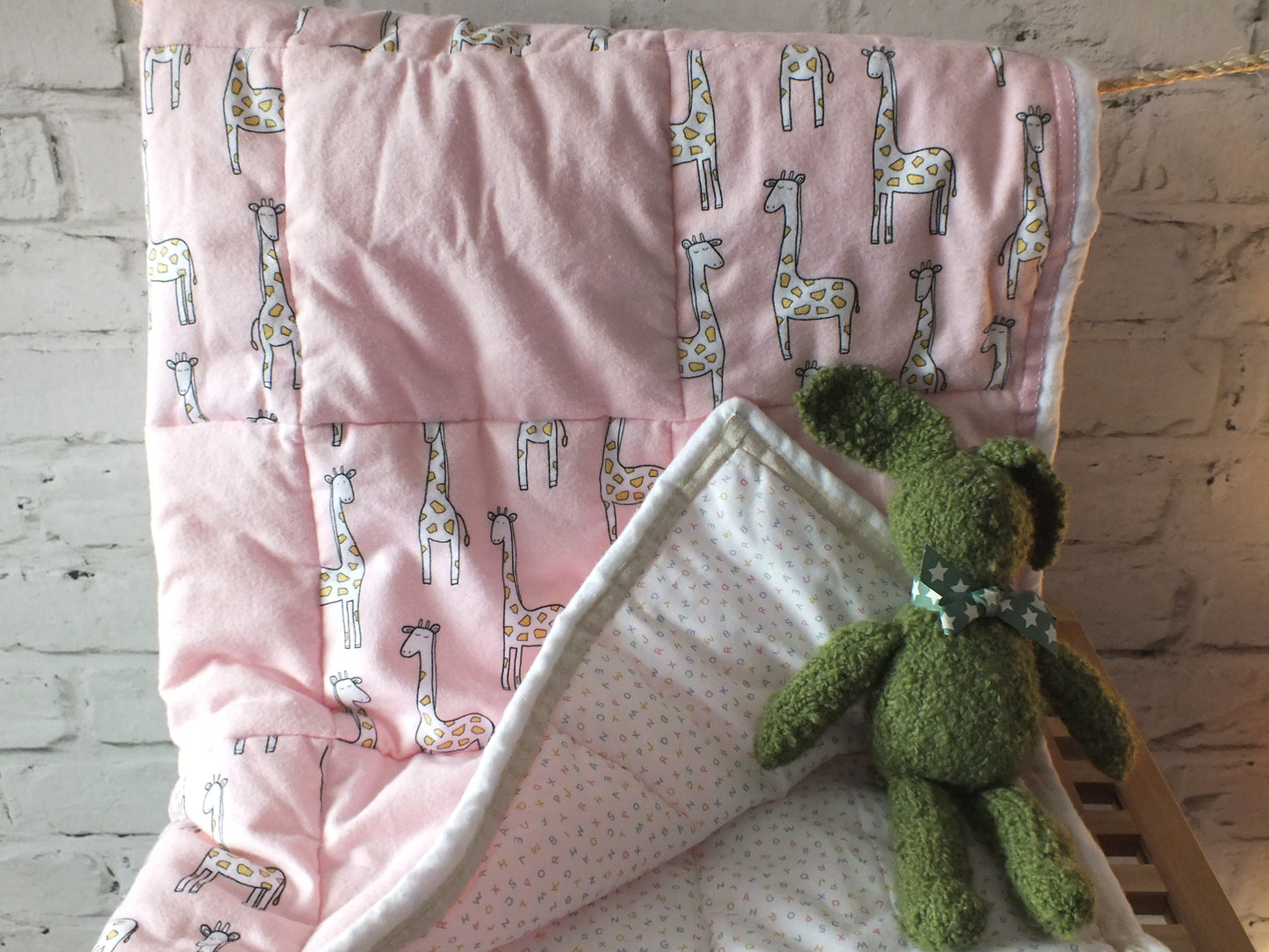 Pink quilted Baby Play Mat or Tummy Time Mat.  Large rectangle hand sewn, lightly quilted using a brushed cotton giraffe fabric with a matching binding and a contrasting cotton backing perfect for Baby Nursery.