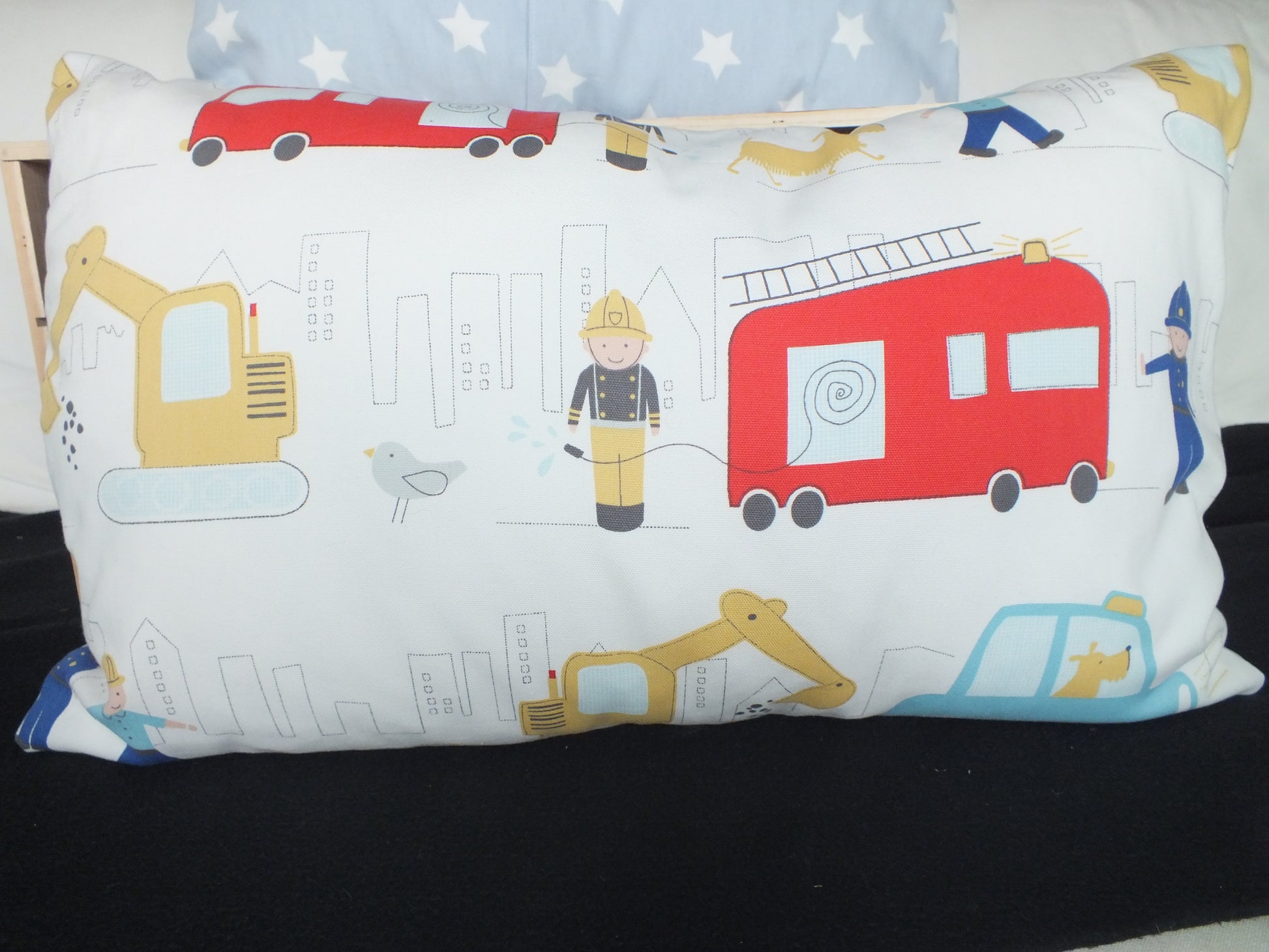 Laura Ashley fire truck and construction fabric Kids Bedroom Cushion, lovely rectangle cushions for children’s bedrooms. Also available in butterfly and spring tree fabric.