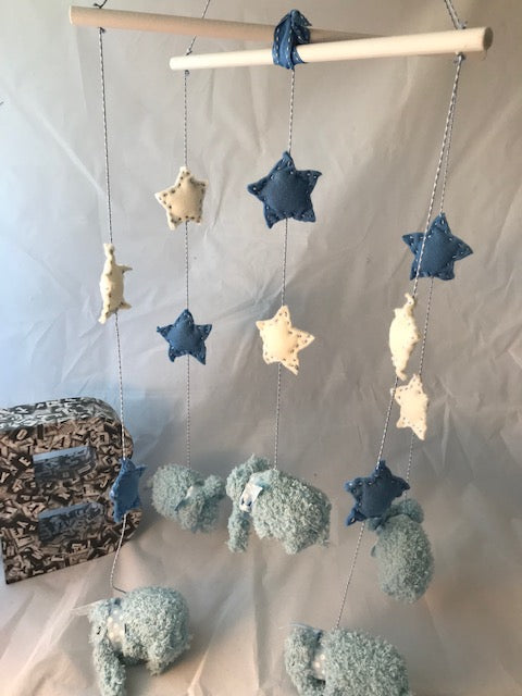 Handmade knitted blue elephants with felt stars baby mobile in shades of blue and white. These unique mobiles are perfect for the baby nursery and for baby shower gifts.
