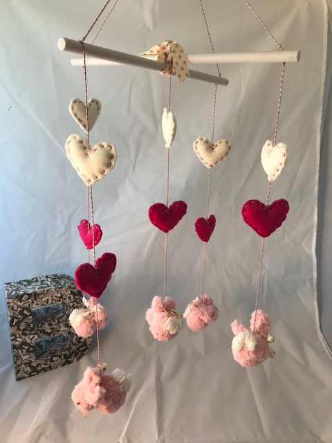 Handmade knitted pink rabbits with felt hearts baby mobile in shades of pinks and white. These unique mobiles are perfect for the baby nursery and for baby shower gifts.