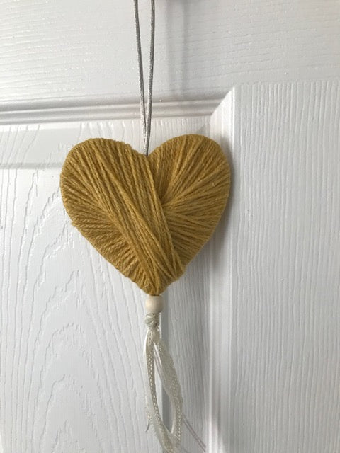 Wool heart hanging gift with lace and a bead. Perfect handmade unique gifts for the home in mustard. Can be hung on a door or pinned to the wall.