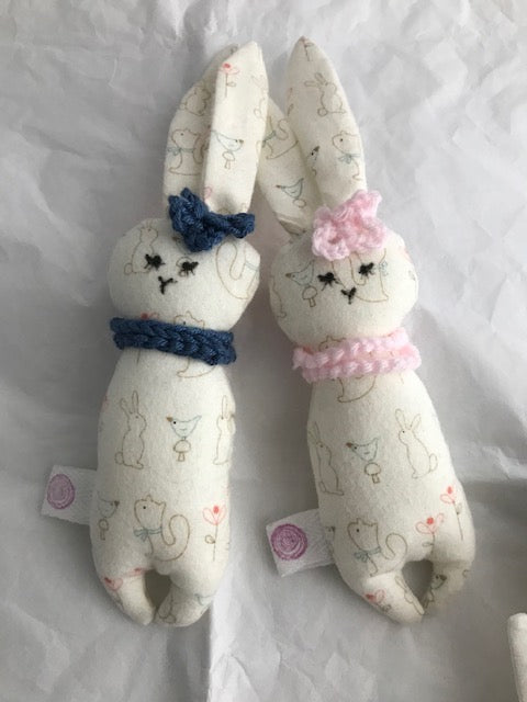 Set of 2 Soft Cloth little Bunnies These lovely little bunnies are uniquely hand crafted and will make a perfect for gift for your baby. They have a pink and blue scarf with a matching flower, everything is sewn down so there are no loose bits.