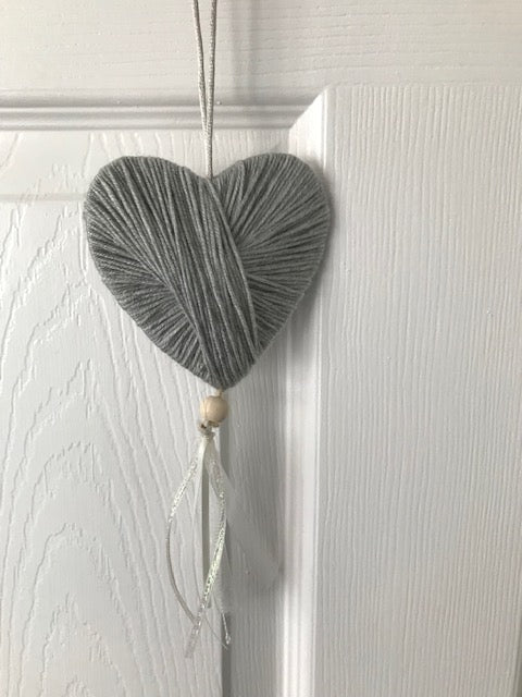 Wool heart hanging gift with lace and a bead. Perfect handmade unique gifts for the home in grey. Can be hung on a door or pinned to the wall.