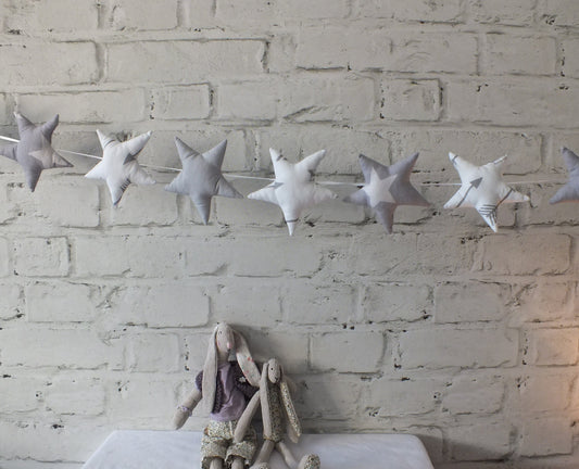 Handmade padded soft grey and white Star Garland threaded on a ribbon string. This makes a perfect baby shower gift in two colours soft grey and white or pink.