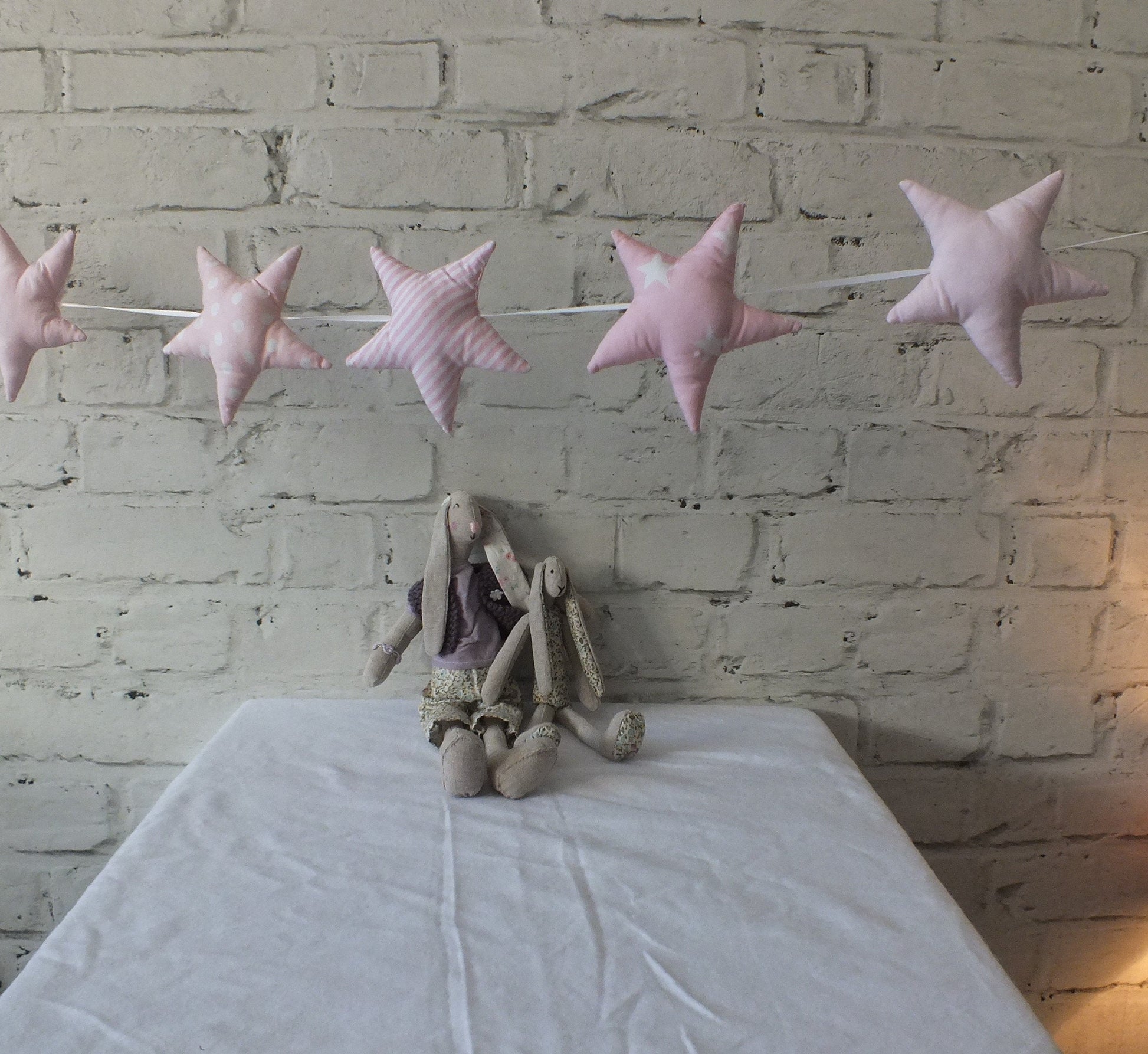 Handmade padded soft pink Star Garland threaded on a ribbon string. This makes a perfect baby shower gift in two colours soft grey and white or pink.