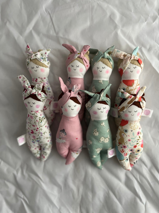 Soft Cloth Doll.  These lovely dolls are hand crafted. Each one has felt hair, the body and top knot headband match. Everything is sewn down so there are no loose bits!  4 colours and choice of hair colour, approximately 16cm tall and 5cm wide perfect for little ones to hold   Machine washable at 30 degrees