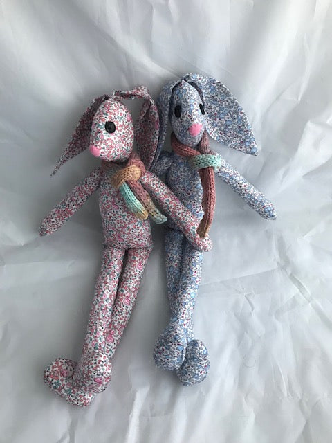 Hand sewn Liberty fabric rabbit, a wonderful gift for a christening or a baby shower gift. The rabbit has a lovely soft body, button eyes, felt nose and a knitted scarf. Each one is 38cm tall and 8cm wide, the floppy ears 13cm long in pink or blue.
