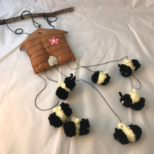 Handmade Felt beehive and Pom Pom bees baby mobile. Seven little bees buzzing around their beehive. These unique mobiles are perfect for the baby nursery and for baby shower gifts.
