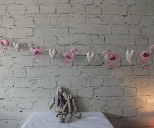 Handmade Flamingo and Heart garland threaded on a  ribbon string approx 1.5m in length. This makes a perfect baby shower gift.  6 flamingos approx (15cm x 9cm) and 6 hearts (approx 8cm x 5cm)