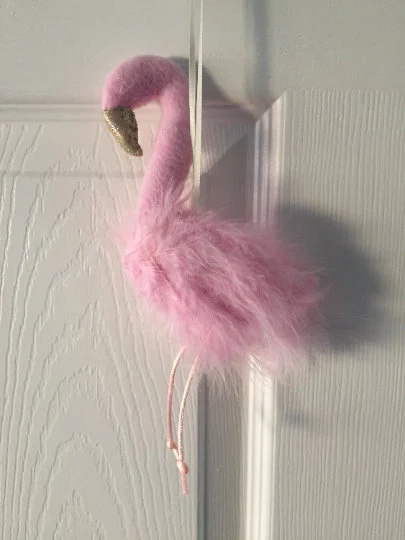 Door hanging pink feather Flamingo perfect for a baby shower gift. This lovely feathered padded flamingo has a ribbon hoop for easy hanging, a sparkly gold beak and long pink legs. Just pop onto the door handle or pin onto the bedroom wall and hang.