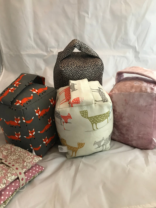 Natural filled hand made cosy doorstop. These cosy fabric doorstops make a perfect accessory for your home or for a gift. Available in various colours and fabrics.  Each one is 16cm width x 12cm high.