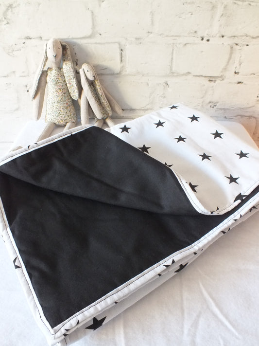 Lightly quilted Black and white stars Baby Play Mat Tummy Time Mat or blanket.  Large rectangle hand sewn, lightly quilted using a light cotton star fabric with a matching binding and a contrasting cotton backing perfect for Baby Nursery