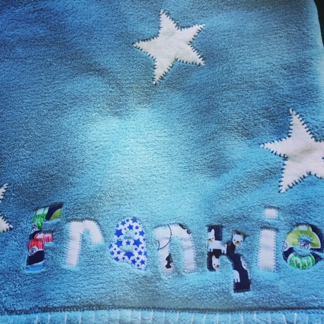 Personalised fleece blanket with soft brushed cotton lining. It can be used for the pushchair or just as a comforter. The blanket is available in Blue, Baby Pink, Soft Grey or Heather and any name can be added. The size is approximately 95cm x 74cm.