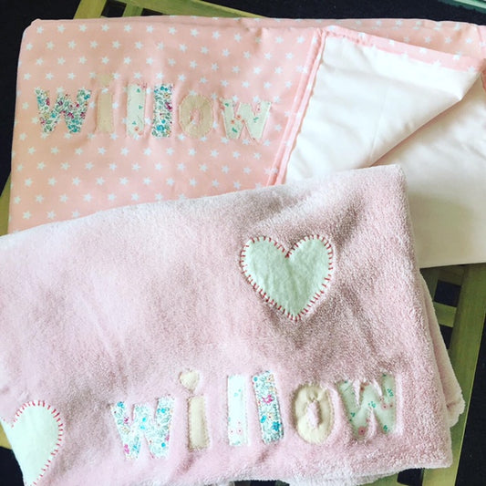 Personalised fleece blanket with soft brushed cotton lining. It can be used for the pushchair or just as a comforter. The blanket is available in Blue, Baby Pink, Soft Grey or Heather and any name can be added. The size is approximately 95cm x 74cm.